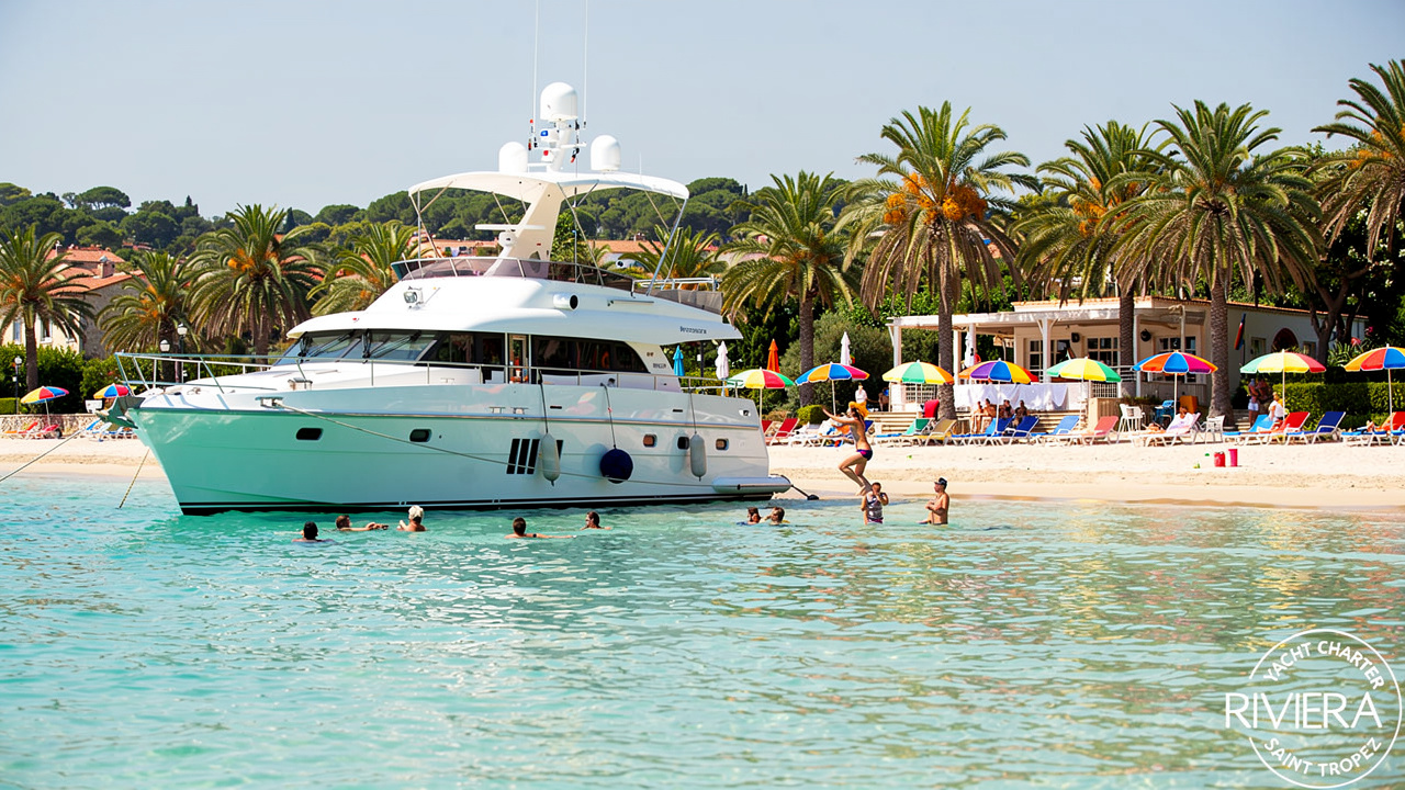 Yacht anchored near a beach club on a day charter